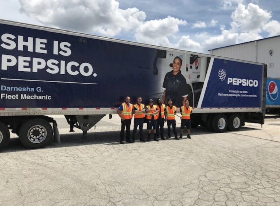 Fleet maintenance team standing together in front of a PepsiCo trailer