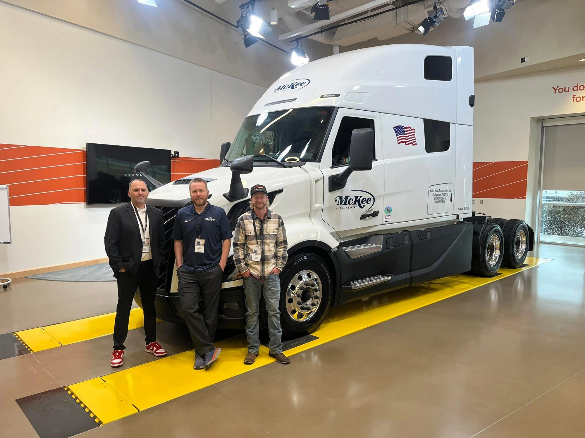 Fleet maintenance colleagues standing beside a McKee Foods truck