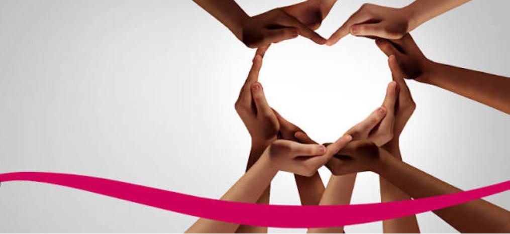 A ring of women’s hands from many skin tones coming together to form the shape of a heart, above a pink ribbon — symbolising the international, women-led SHE-HEALS collaboration.
