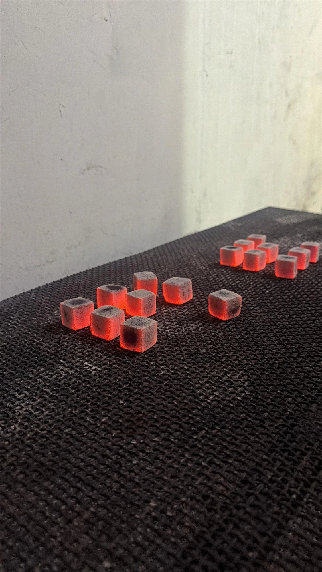 Glowing coconut charcoal cube briquettes