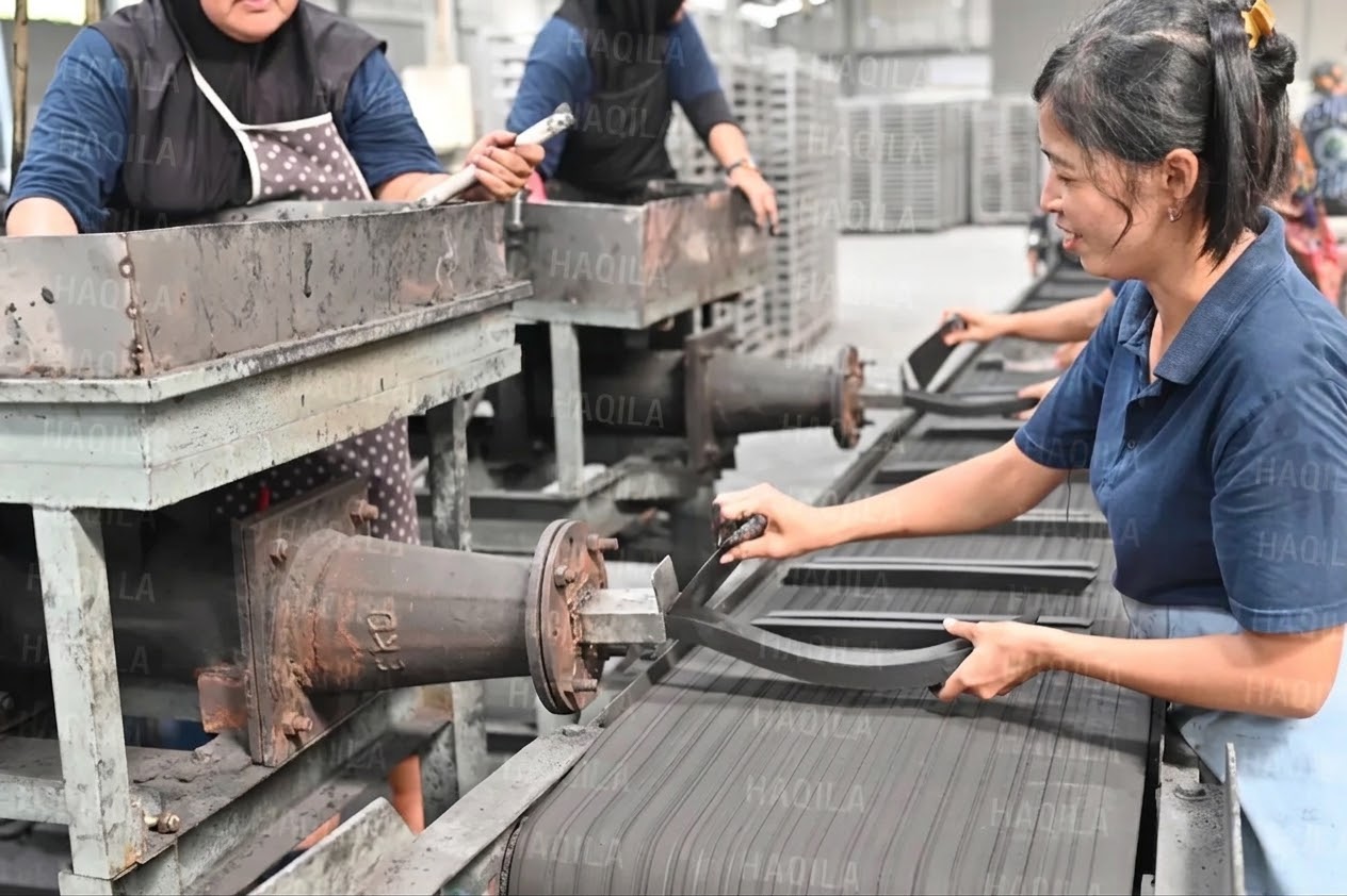 Skilled worker attending the production line at a manufacturing partner's facility