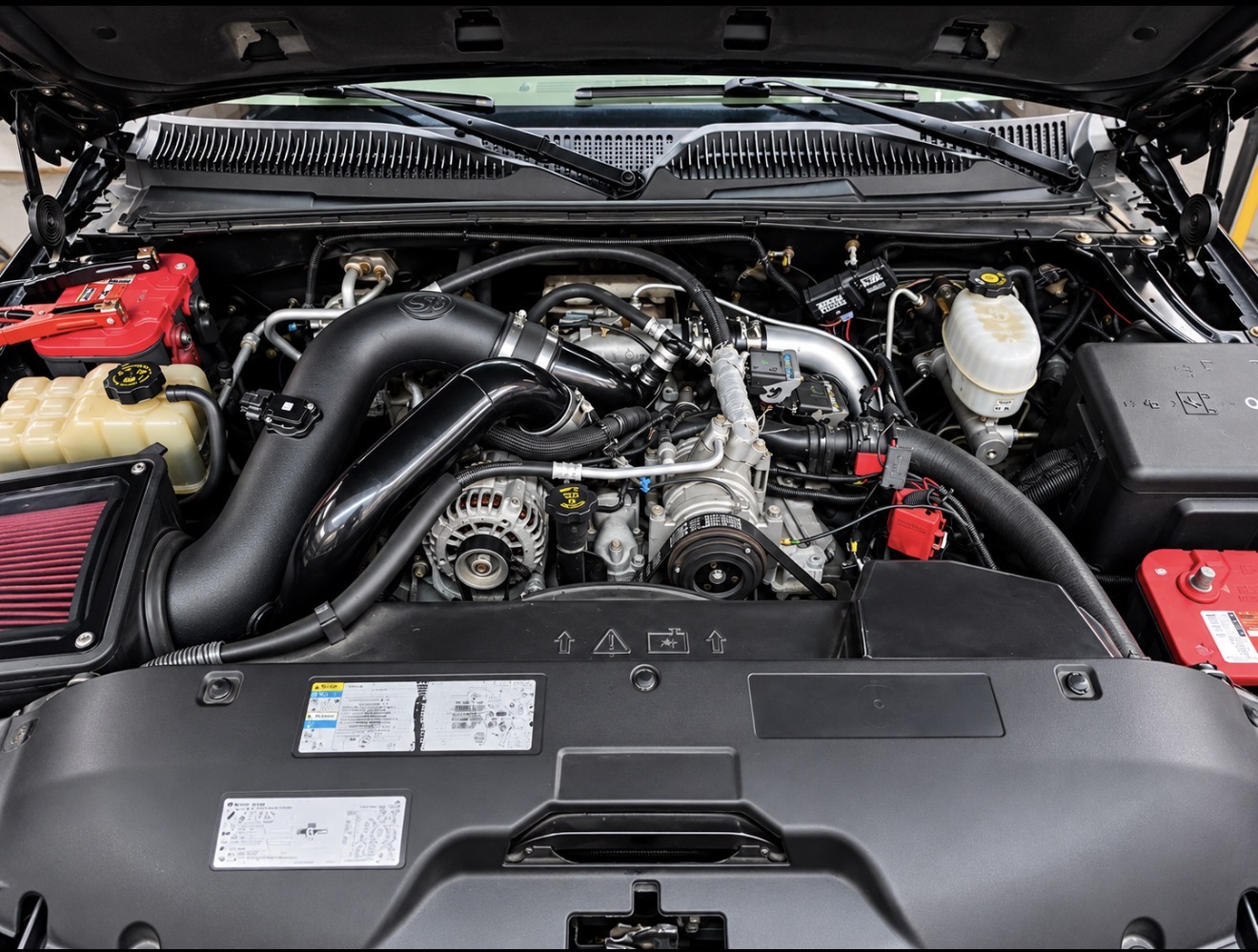 Red powder-coated intake piping in an engine bay