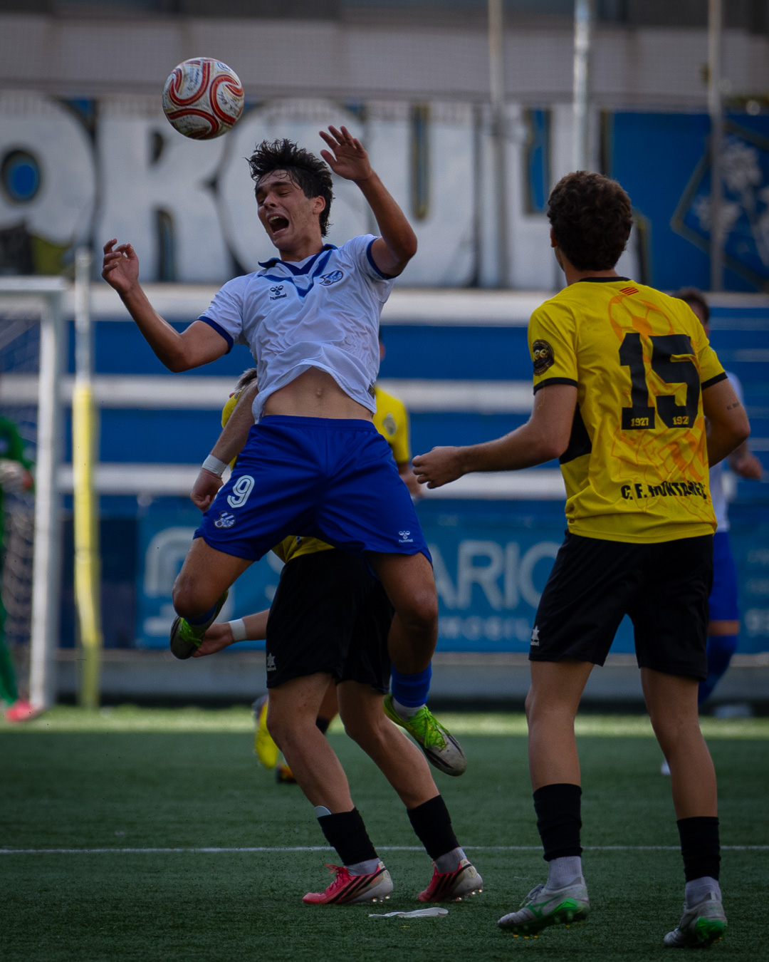 Player #14 driving forward with the ball at pace
