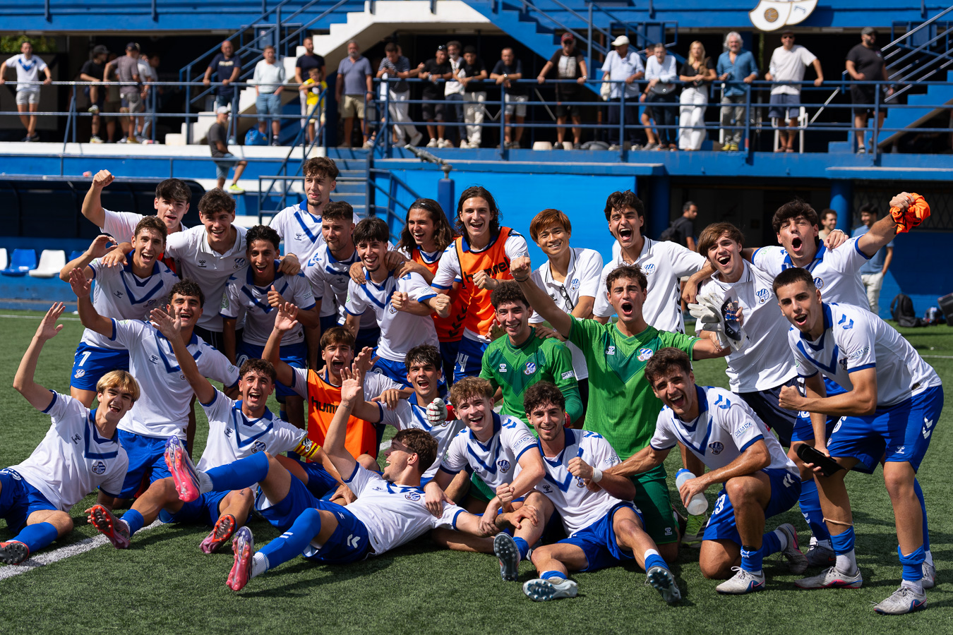Full squad celebrating a win in front of the home stand