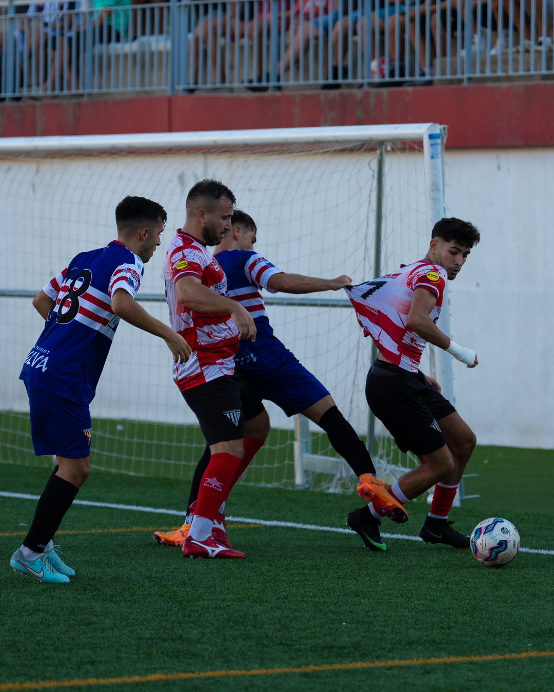 Striker swinging to volley the ball under pressure