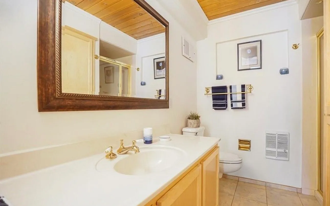 Clean cabin kitchen with stainless appliances and stone counters