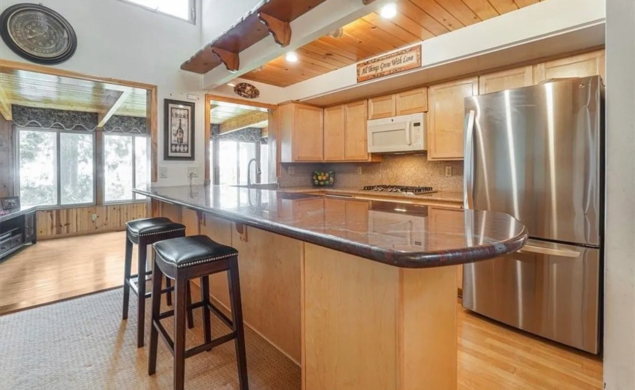 Bright mountain-home living room with vaulted wood-beam ceiling