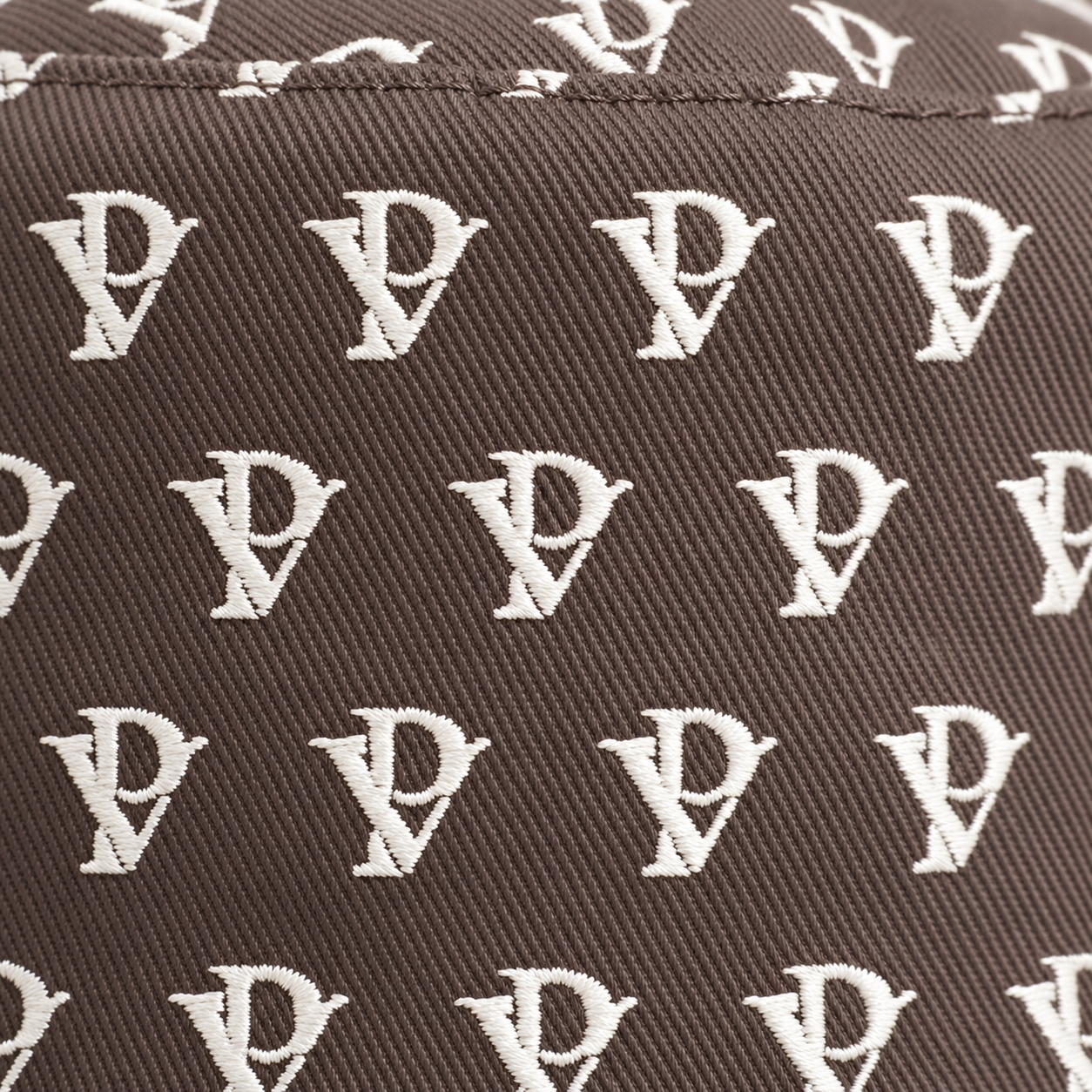 Monogram Reversible Bucket Hat — Taupe in Taupe — worn by a model