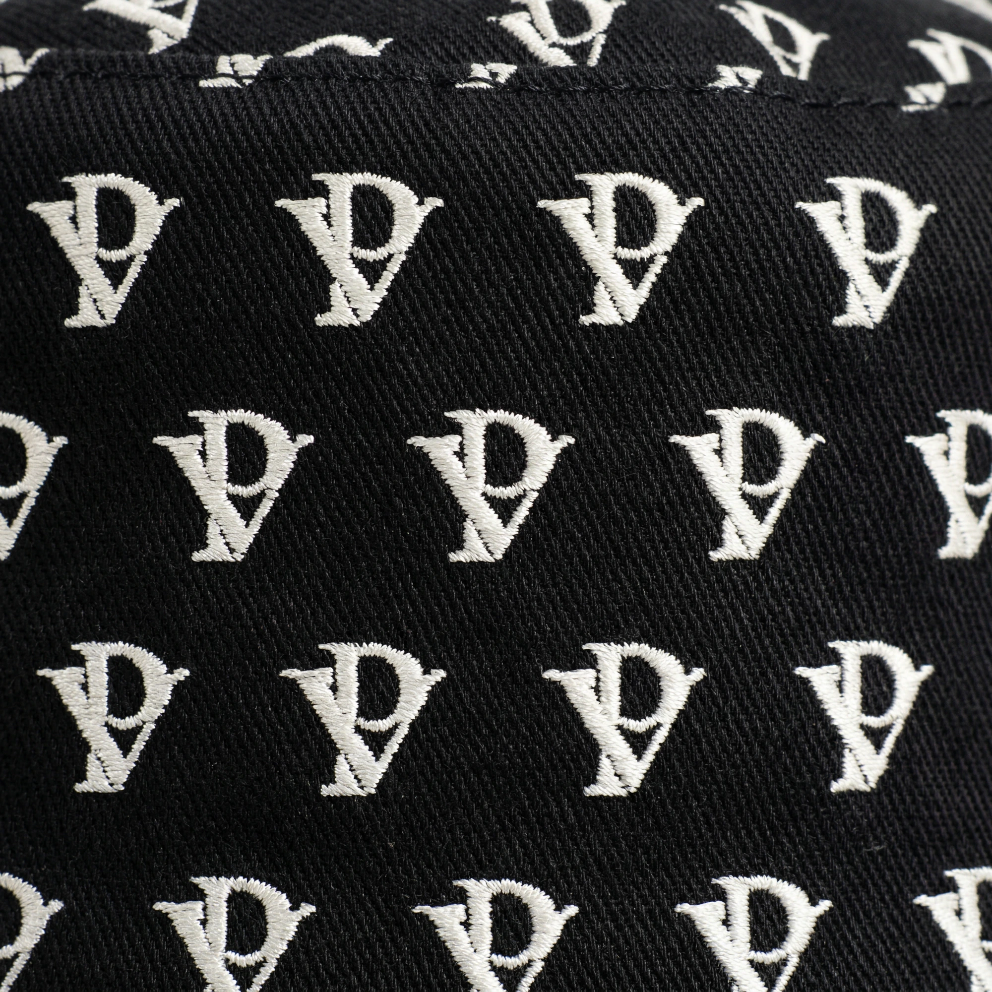 Monogram Reversible Bucket Hat — Noir in Noir — worn by a model