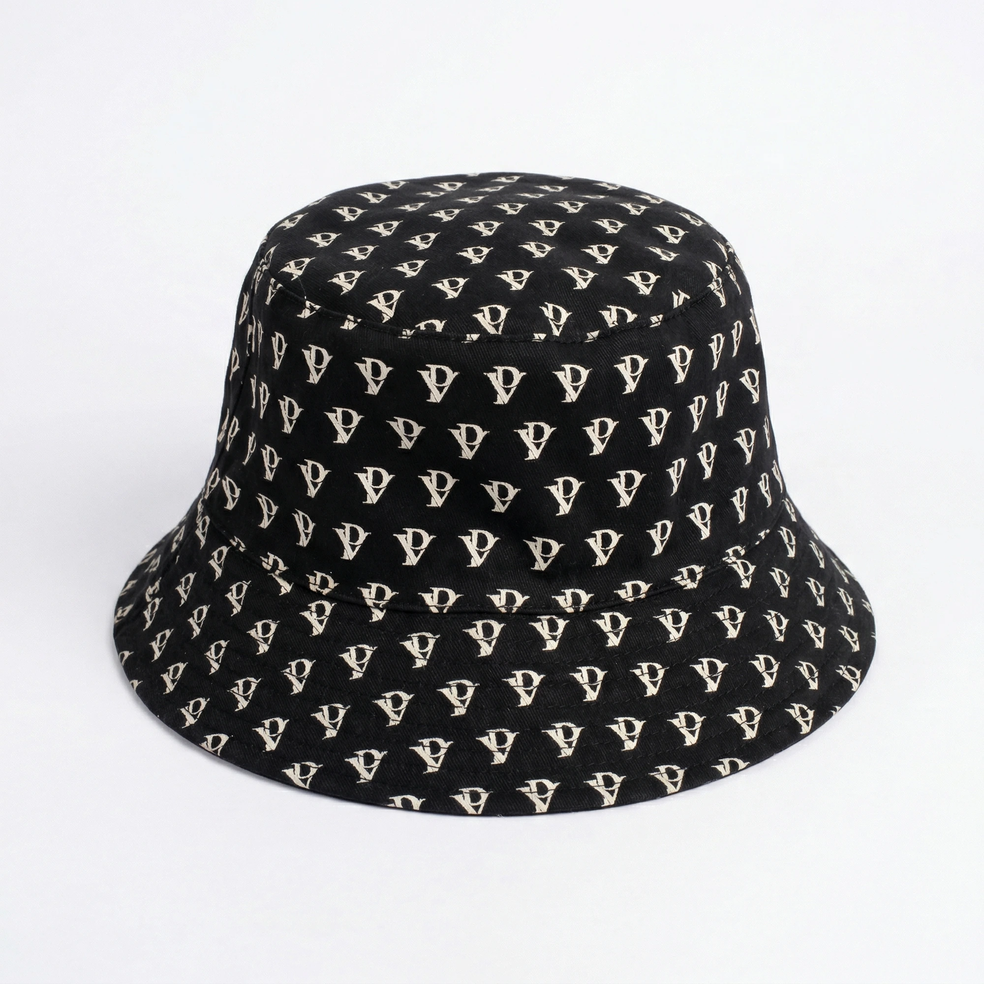 Monogram Reversible Bucket Hat — Noir in Noir — worn by a model