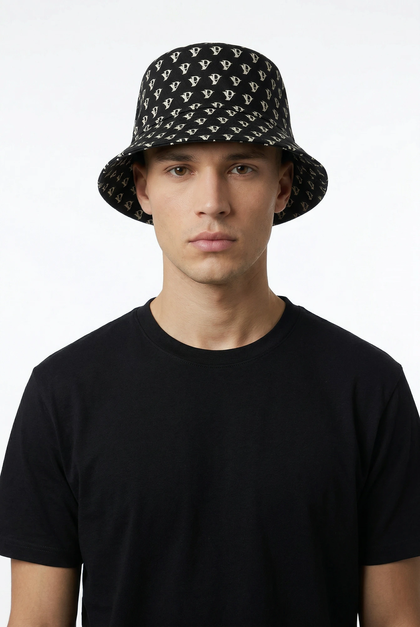 Monogram Reversible Bucket Hat — Noir in Noir — worn by a model
